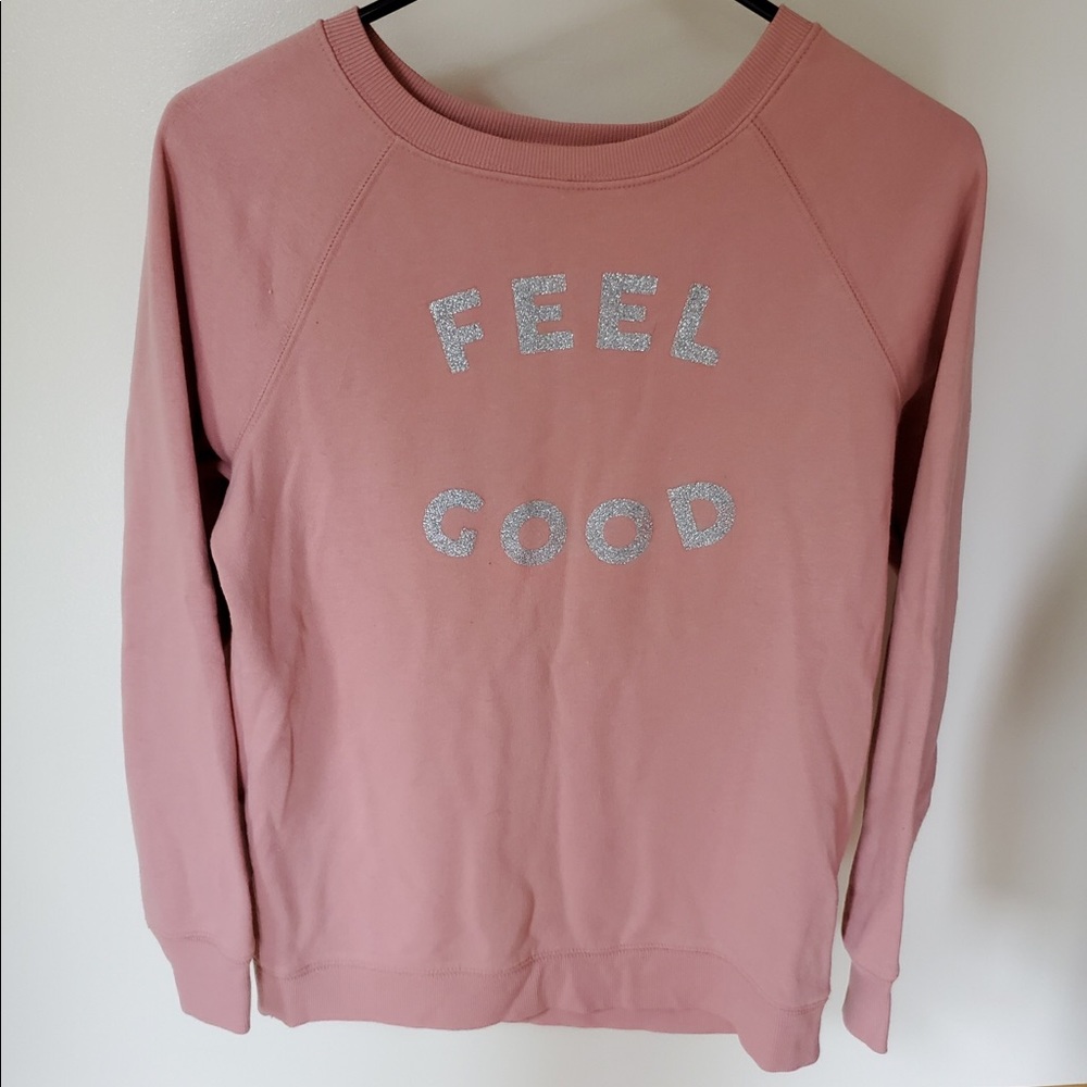 I’m selling a pink “feel good” long sleeve shirt.